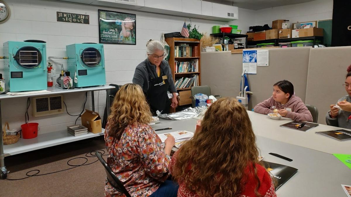 Students of various ages listen to instructor Gretchen Manker.