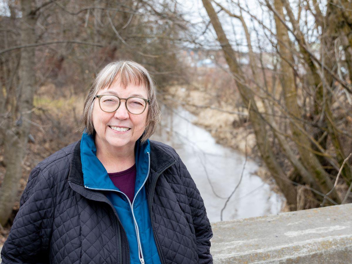 Karen Hume posing in front of a river