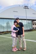 A mother and son 立场。 on the practice field of the P1FCU-Kibbie Activity Center.