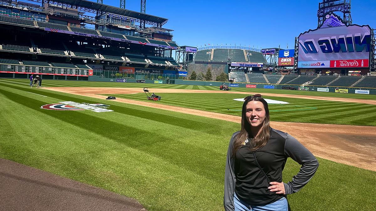 Photo of woman on a baseball field.