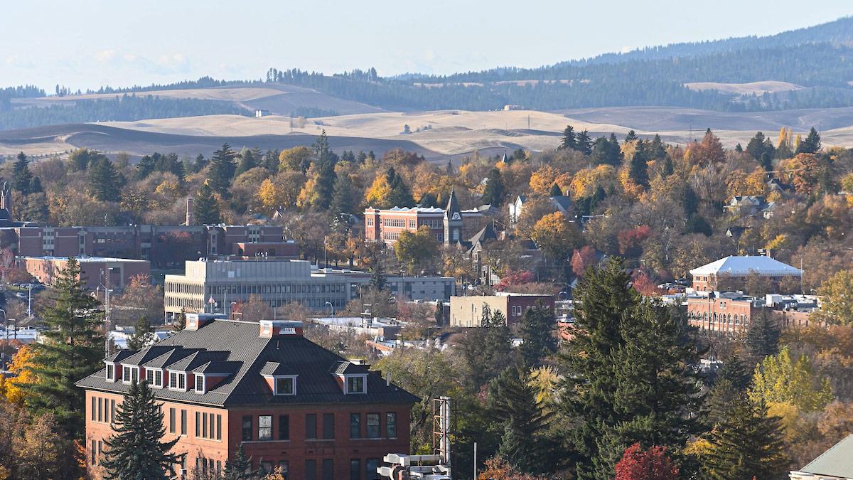 An aerial view of Moscow, looking east from campus, with the edge of Moscow Mountain in the background and the deciduous trees around town starting to turn yellow.